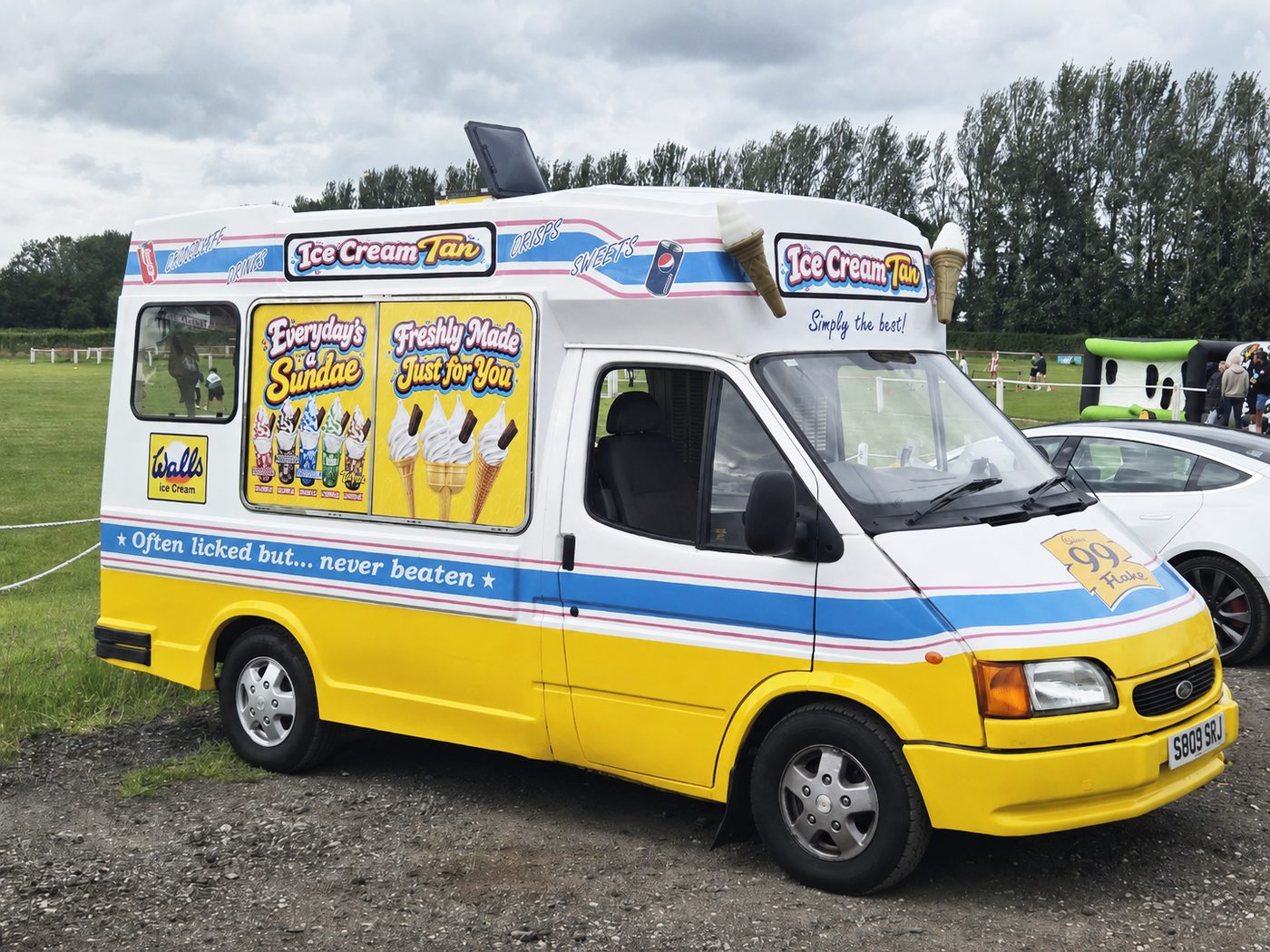 Ice T's Ice Creams van, a classic yellow and blue ice cream van, parked at an event in Knutsford, Cheshire