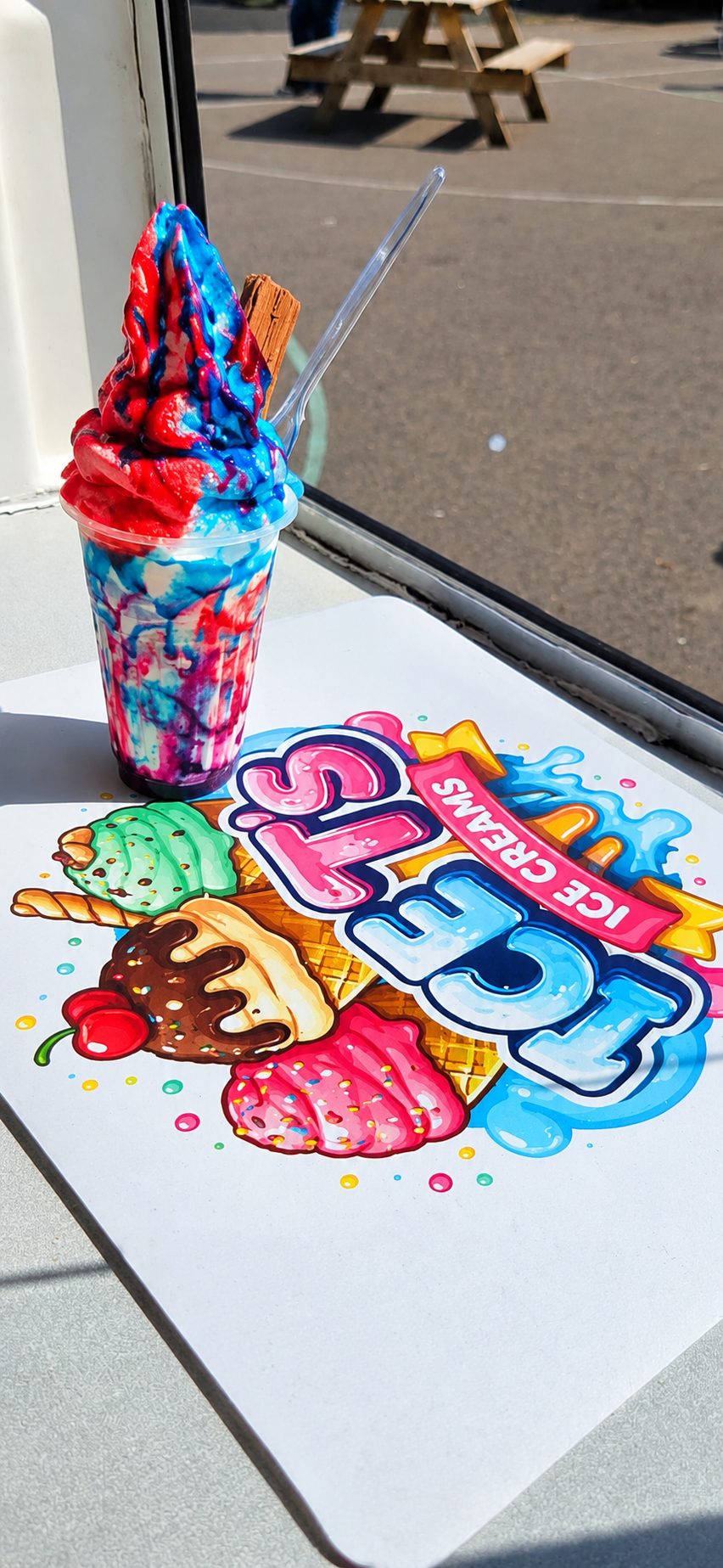 Rainbow sherbet soft whip ice cream with a flake, served in Northwich, Cheshire